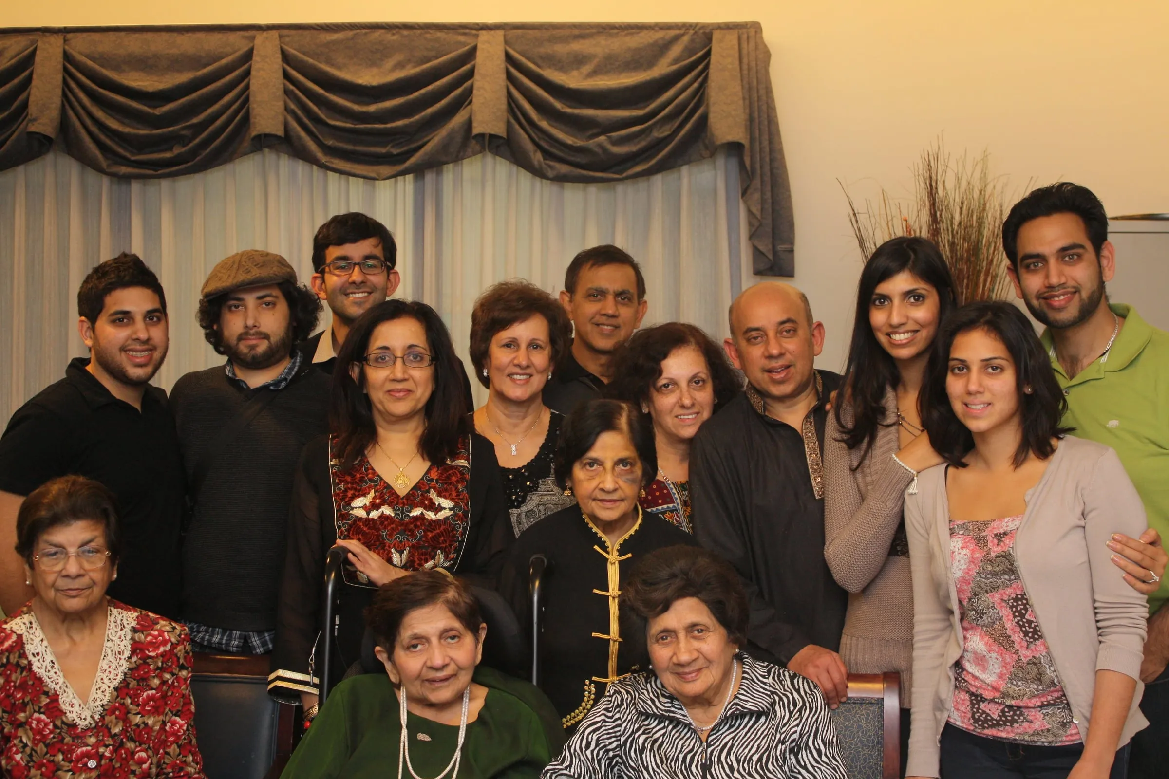 A large group of family and friends posing together in a living room