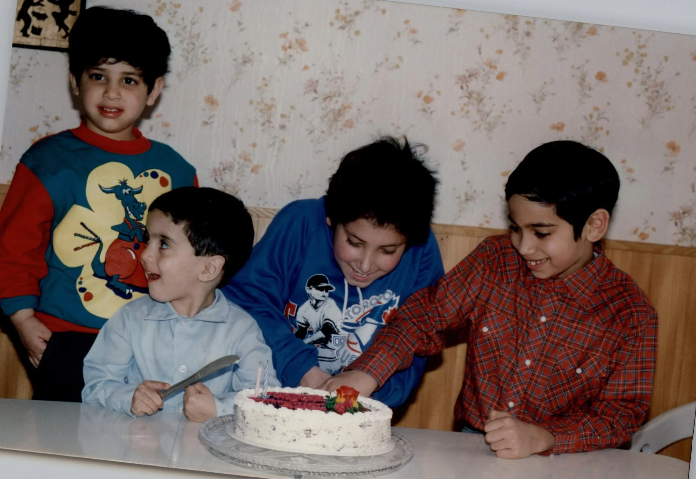 Four boys around a birthday cake