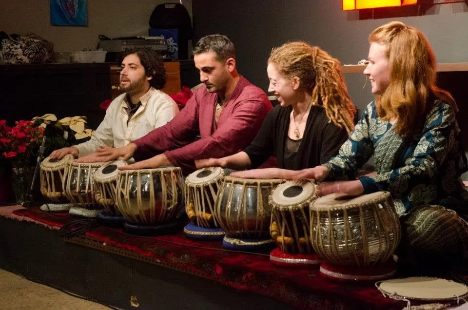 Four people playing tabla