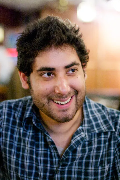 Jehangir smiling, in a plaid shirt